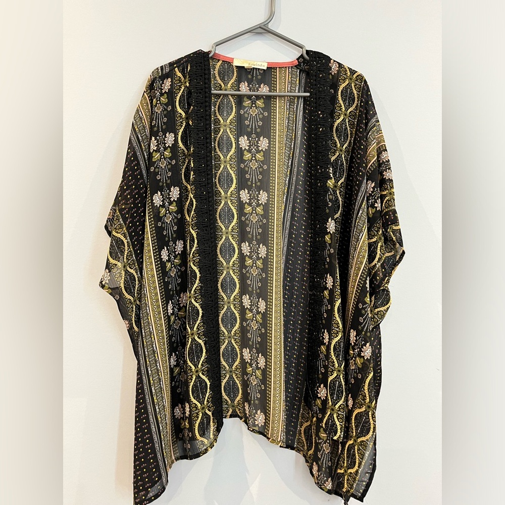 Loose open kimono style top with embroidered edges.